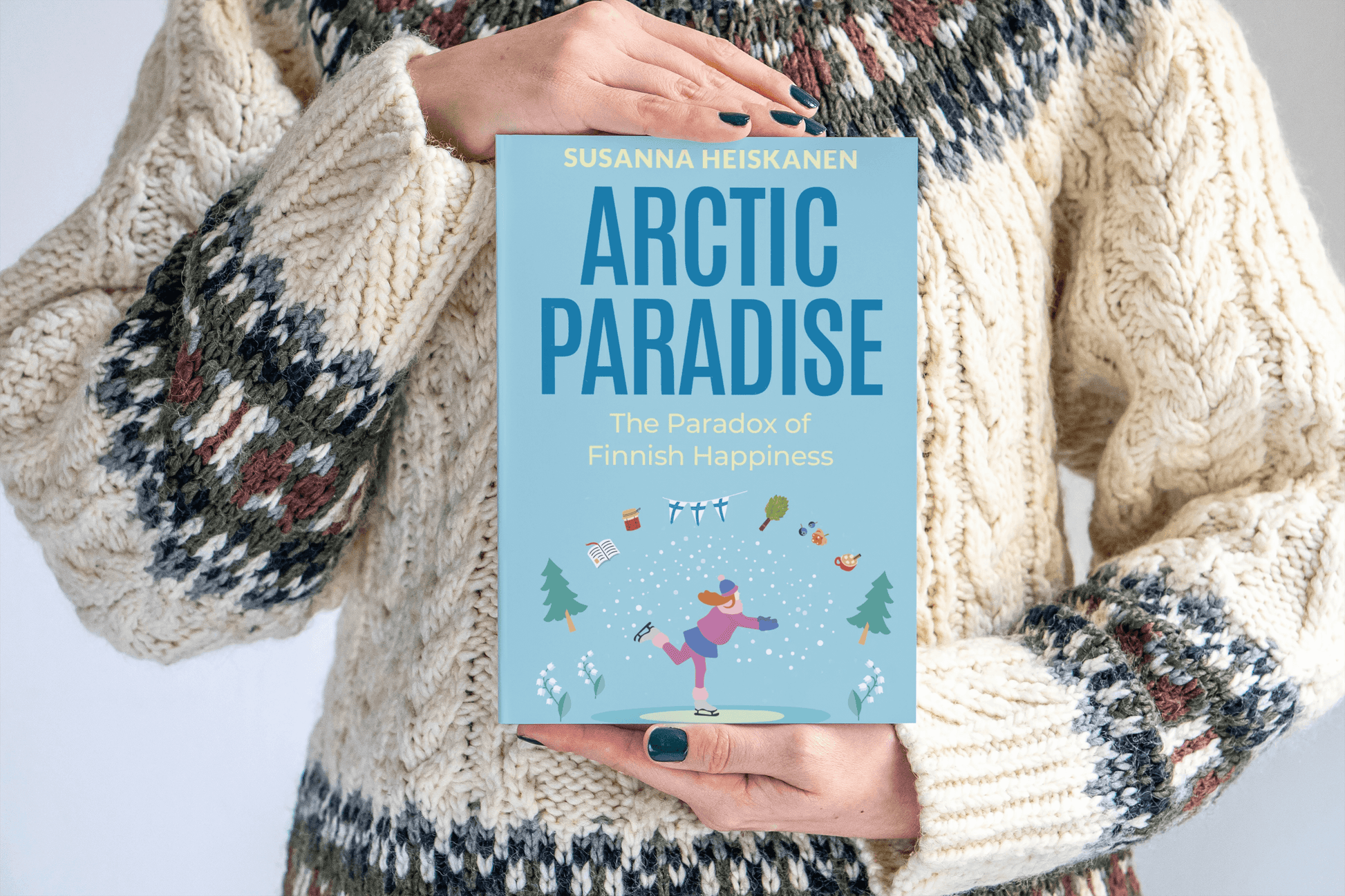 Arctic-Paradise-Paperback-Cover-Held-on-hand-with-Icelandic-Jumper